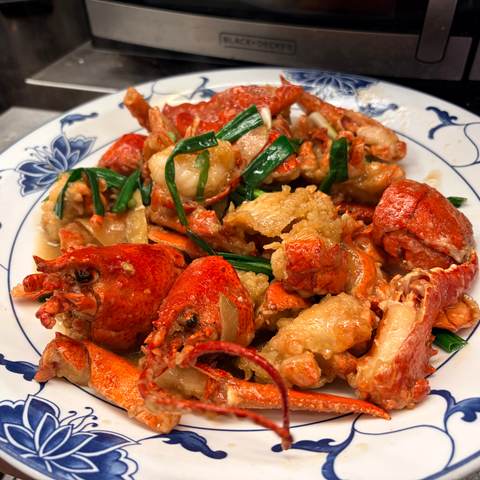 Two lobsters with ginger & scallions, photographed